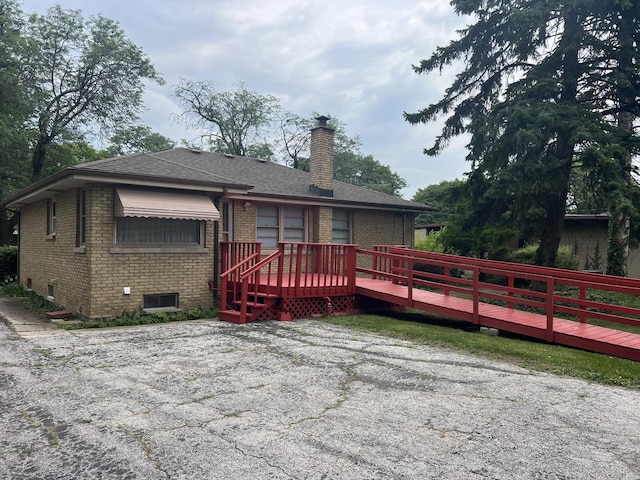 243 E 170th St, South Holland, IL 60473 - rear view of property featuring brick siding, a deck, a chimney, and roof with shingles