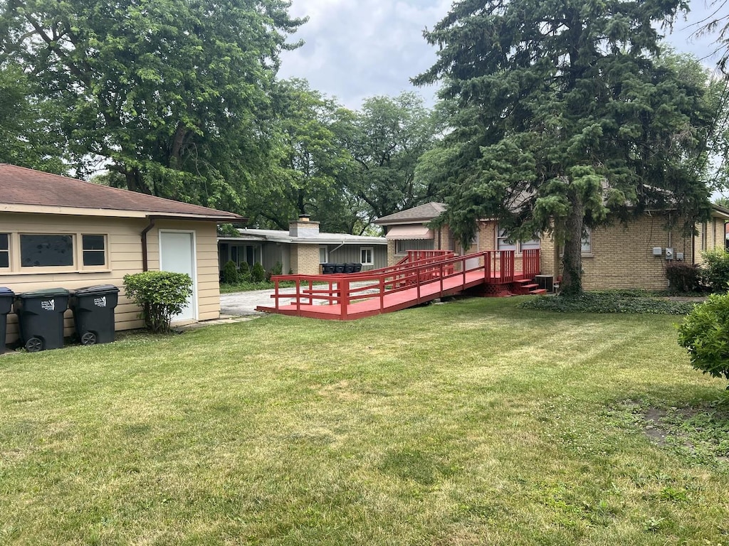 243 E 170th St, South Holland, IL 60473 - view of green lawn with a wooden deck