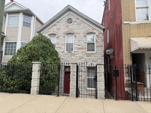 1720 W 17th St, Chicago, IL 60608 - view of front of home featuring a fenced front yard, stone siding, and a gate