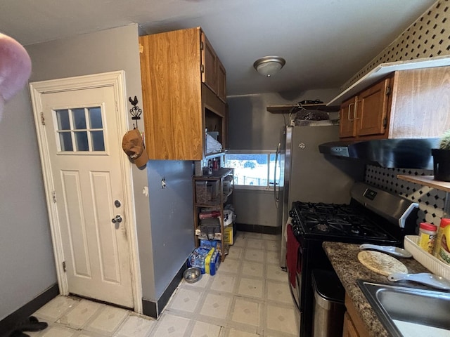 5409 S Richmond St, Chicago, IL 60632 - kitchen featuring black range with gas cooktop, light flooring, range hood, and brown cabinets