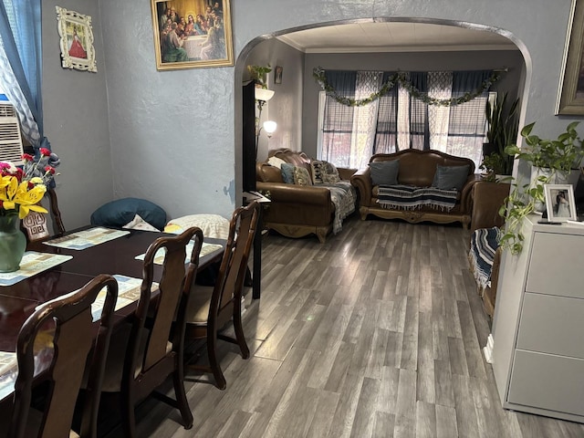 5409 S Richmond St, Chicago, IL 60632 - dining space featuring a textured wall, arched walkways, wood finished floors, and ornamental molding