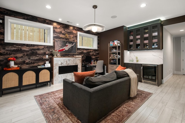 2441 N Clybourn Ave Unit 1, Chicago, IL 60614 - living area featuring a high end fireplace, light wood finished floors, recessed lighting, and a bar
