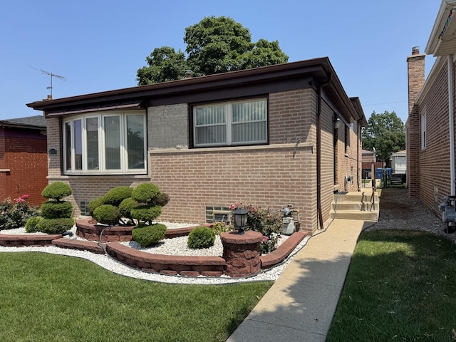 11117 S S Ave L, Chicago, IL 60617 - view of home's exterior featuring brick siding and a lawn