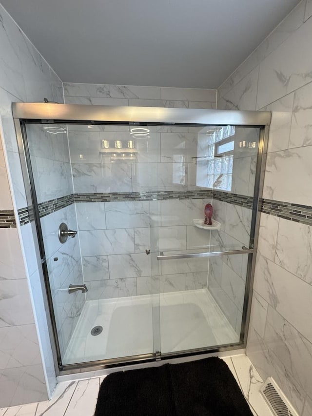 11117 S S Ave L, Chicago, IL 60617 - bathroom featuring a stall shower and marble finish flooring