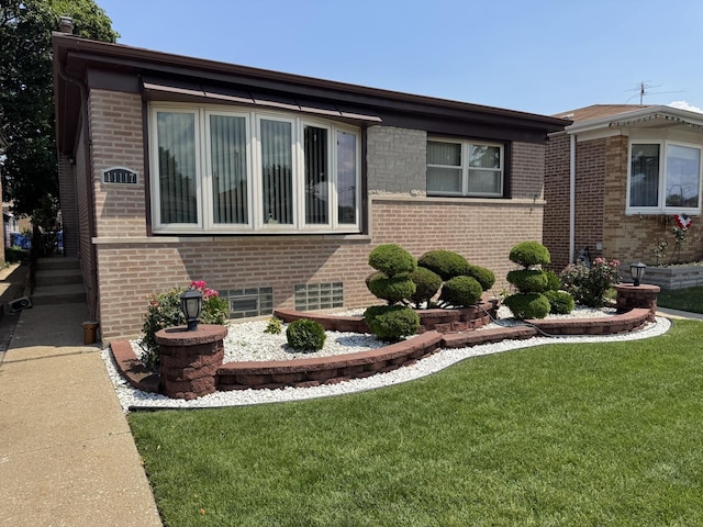 11117 S S Ave L, Chicago, IL 60617 - view of property exterior with brick siding and a yard