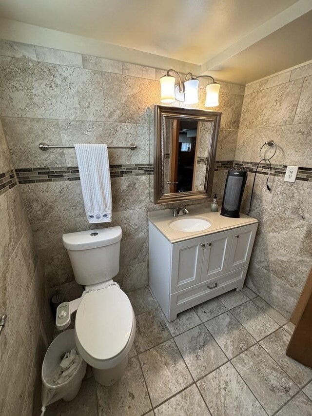 11117 S S Ave L, Chicago, IL 60617 - half bathroom with tile walls, vanity, and tile patterned floors