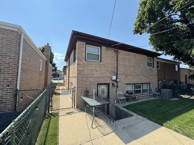 11117 S S Ave L, Chicago, IL 60617 - rear view of house with a gate, brick siding, and a patio