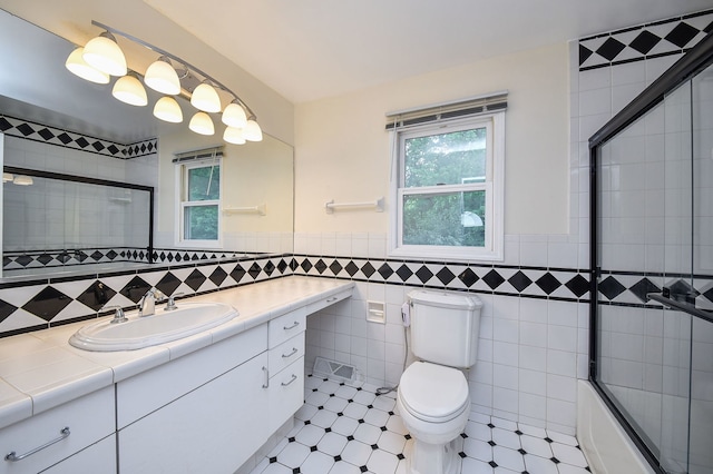 339 Windsor Dr, Bartlett, IL 60103 - full bath with vanity, combined bath / shower with glass door, tile walls, and wainscoting