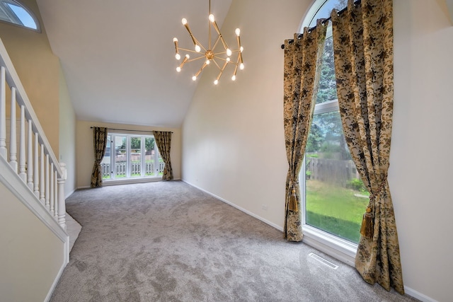 339 Windsor Dr, Bartlett, IL 60103 - unfurnished living room with high vaulted ceiling, carpet flooring, a chandelier, and stairway