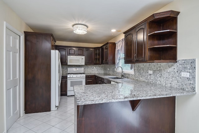 339 Windsor Dr, Bartlett, IL 60103 - kitchen with white appliances, a peninsula, light tile patterned flooring, dark brown cabinets, and open shelves