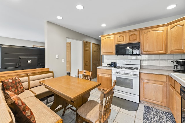 18211 Eagle Dr, Tinley Park, IL 60477 - kitchen featuring black microwave, white gas stove, tasteful backsplash, light countertops, and recessed lighting