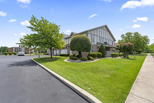 18211 Eagle Dr, Tinley Park, IL 60477 - view of front of property featuring board and batten siding, brick siding, a front lawn, an attached garage, and driveway