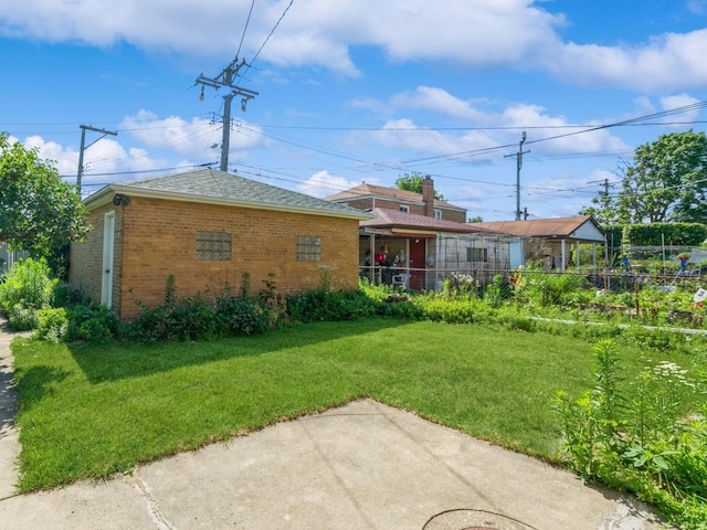 5547 N California Ave, Chicago, IL 60625 - rear view of house featuring brick siding, a patio area, and roof with shingles