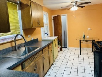 5547 N California Ave, Chicago, IL 60625 - kitchen with a ceiling fan, dark countertops, and brown cabinetry