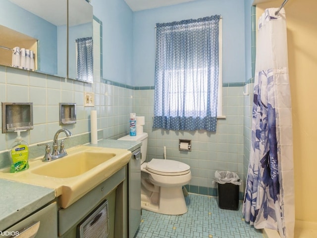 5547 N California Ave, Chicago, IL 60625 - bathroom featuring vanity, tile patterned floors, a shower with curtain, tile walls, and a wainscoted wall