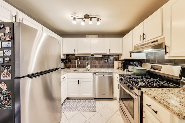 1042 Quanset Ct, Schaumburg, IL 60194 - kitchen featuring appliances with stainless steel finishes, under cabinet range hood, light tile patterned floors, tasteful backsplash, and white cabinets