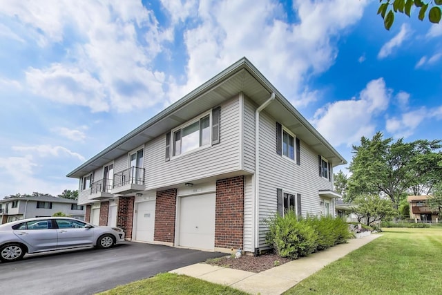 1042 Quanset Ct, Schaumburg, IL 60194 - view of front of home with a garage, brick siding, driveway, and a front yard