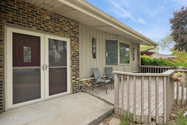 715 N Lawler Ave, Addison, IL 60101 - entrance to property featuring board and batten siding, brick siding, and a wooden deck