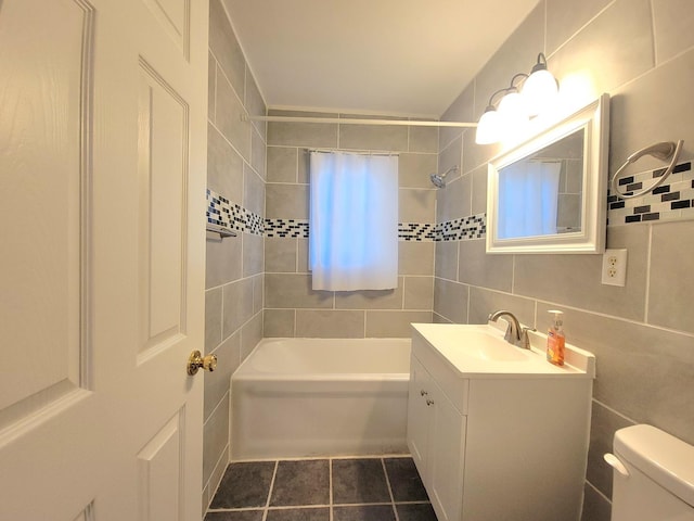 1357 Morgan St, Joliet, IL 60436 - bathroom featuring tile walls, vanity, tub / shower combination, tasteful backsplash, and tile patterned floors