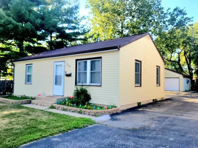1357 Morgan St, Joliet, IL 60436 - bungalow-style home featuring an outbuilding, a garage, and a front yard