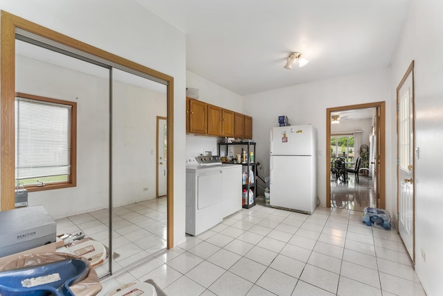 1007 Wildwood Ln, Mount Prospect, IL 60056 - kitchen with freestanding refrigerator, washing machine and clothes dryer, brown cabinetry, ceiling fan, and light tile patterned flooring