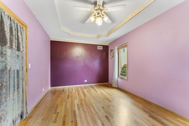 1007 Wildwood Ln, Mount Prospect, IL 60056 - spare room featuring a tray ceiling, wood finished floors, and ceiling fan