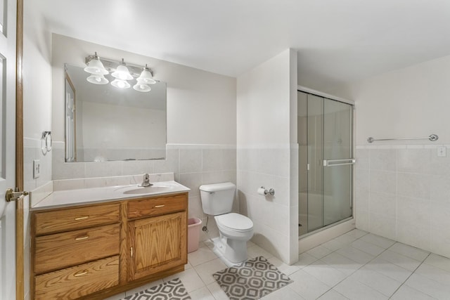 1007 Wildwood Ln, Mount Prospect, IL 60056 - full bathroom featuring tile walls, vanity, a shower stall, tile patterned floors, and a wainscoted wall
