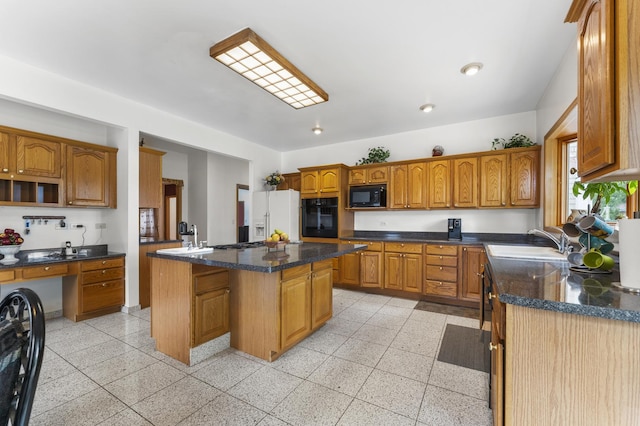 1007 Wildwood Ln, Mount Prospect, IL 60056 - kitchen with black appliances, brown cabinets, a center island, and dark stone countertops