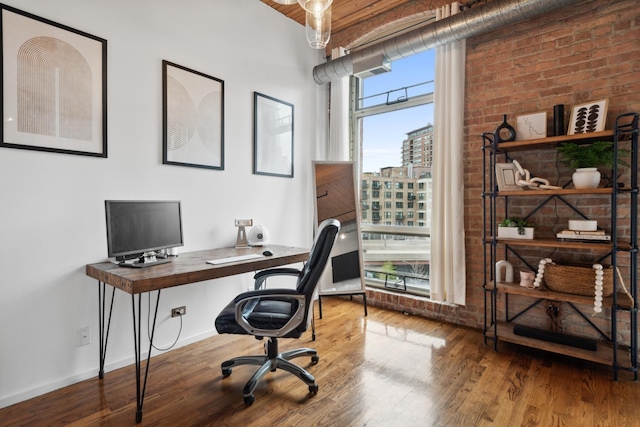 550 N Kingsbury St Unit 515, Chicago, IL 60654 - home office with wood finished floors and brick wall