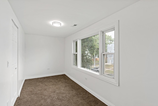 1668 Buena Vista Ave, Chicago Heights, IL 60411 - empty room featuring dark colored carpet and baseboards