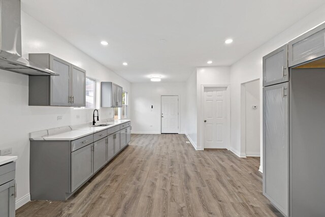 1668 Buena Vista Ave, Chicago Heights, IL 60411 - kitchen featuring gray cabinetry, ventilation hood, light wood-style flooring, light countertops, and recessed lighting