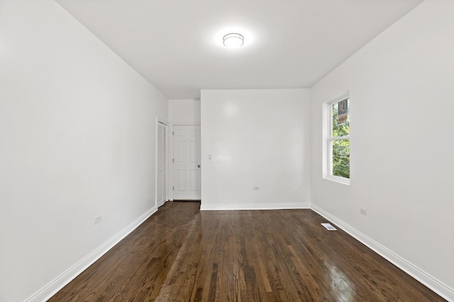 1668 Buena Vista Ave, Chicago Heights, IL 60411 - spare room featuring dark wood-type flooring and baseboards
