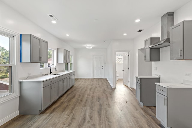 1668 Buena Vista Ave, Chicago Heights, IL 60411 - kitchen with gray cabinetry, wall chimney range hood, and recessed lighting