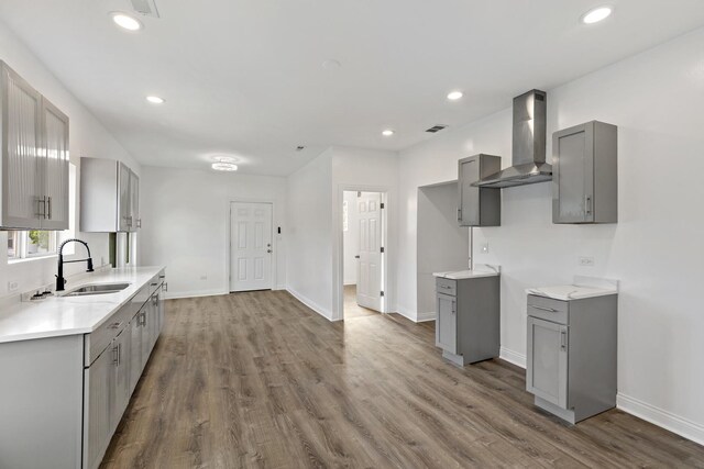 1668 Buena Vista Ave, Chicago Heights, IL 60411 - kitchen with gray cabinets, wall chimney exhaust hood, wood finished floors, light countertops, and recessed lighting