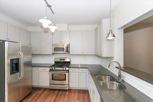 1137 N Claremont Dr, Palatine, IL 60074 - kitchen with stainless steel appliances, dark countertops, tasteful backsplash, dark wood finished floors, and hanging light fixtures