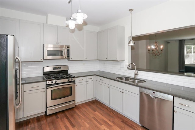 1137 N Claremont Dr, Palatine, IL 60074 - kitchen featuring appliances with stainless steel finishes, a chandelier, dark countertops, and backsplash
