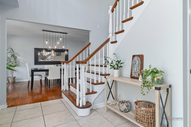555 W Everett Rd, Lake Forest, IL 60045 - stairs featuring tile patterned flooring and a chandelier