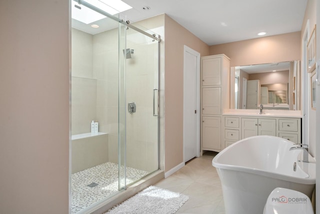 555 W Everett Rd, Lake Forest, IL 60045 - bathroom featuring a skylight, a stall shower, a freestanding tub, and tile patterned flooring