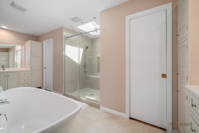 555 W Everett Rd, Lake Forest, IL 60045 - bathroom with vanity, a stall shower, a freestanding tub, recessed lighting, and tile patterned floors