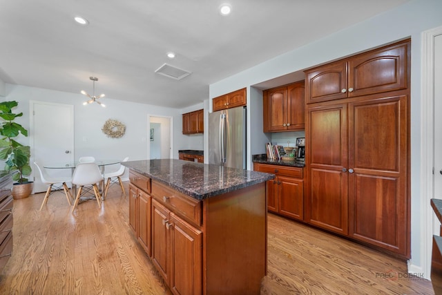 555 W Everett Rd, Lake Forest, IL 60045 - kitchen with freestanding refrigerator, light wood finished floors, a kitchen island, brown cabinets, and recessed lighting