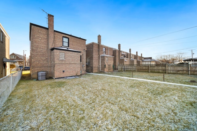 10806 S Vernon Ave, Chicago, IL 60628 - back of house with a fenced backyard, brick siding, and a chimney