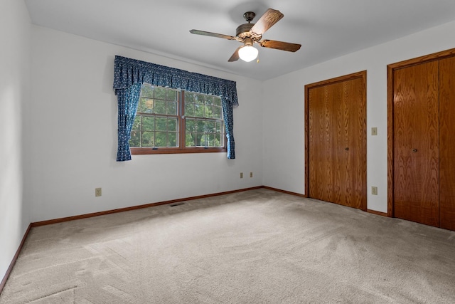 23201 Norma Ln, Harvard, IL 60033 - unfurnished bedroom featuring carpet flooring, ceiling fan, and two closets