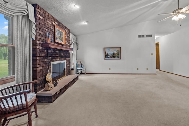 23201 Norma Ln, Harvard, IL 60033 - carpeted living area featuring vaulted ceiling, a brick fireplace, and ceiling fan