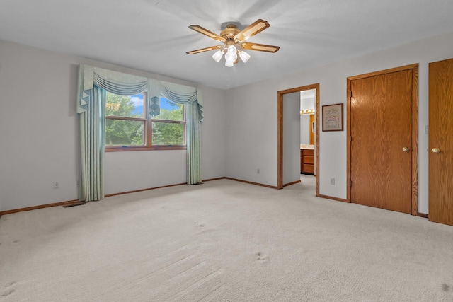 23201 Norma Ln, Harvard, IL 60033 - unfurnished bedroom featuring light carpet, connected bathroom, and ceiling fan