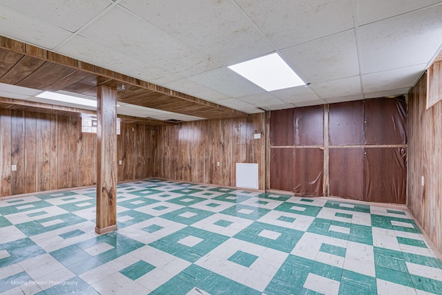 8822 S Paulina St, Chicago, IL 60620 - finished basement with tile patterned floors, wooden walls, and a drop ceiling