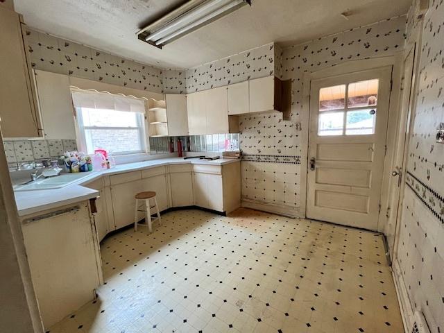2722 Euclid Ave, Berwyn, IL 60402 - kitchen with light floors, open shelves, light countertops, and wallpapered walls