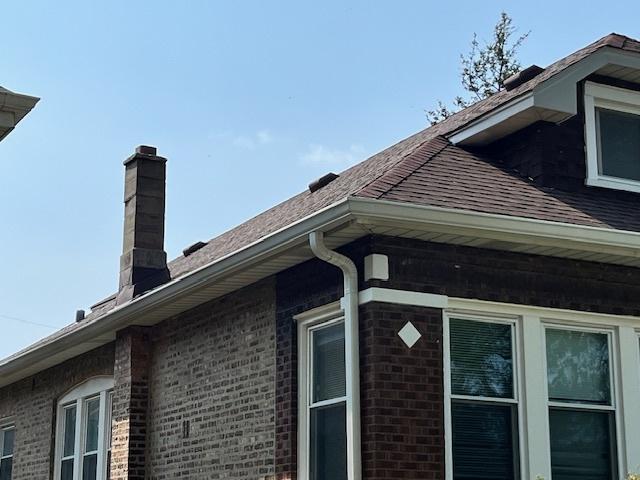 2722 Euclid Ave, Berwyn, IL 60402 - exterior view of brick siding, a chimney, a downspout, and gutters
