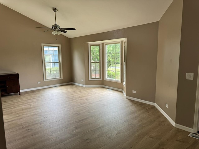 2404 Kenmore Ct, Schaumburg, IL 60193 - unfurnished room featuring healthy amount of natural light, a ceiling fan, vaulted ceiling, and wood finished floors