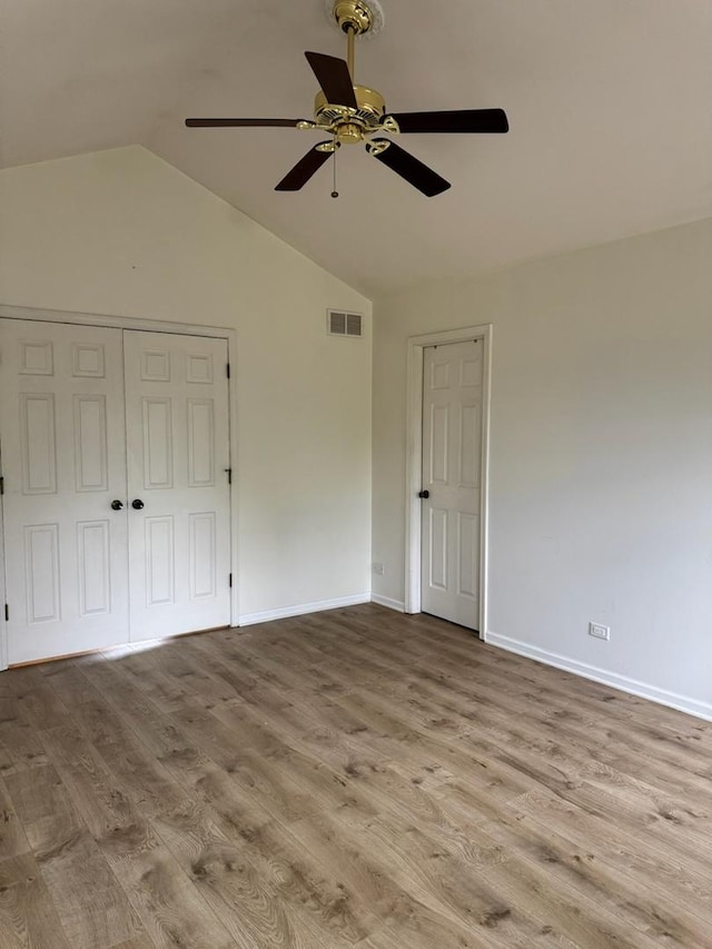 2404 Kenmore Ct, Schaumburg, IL 60193 - unfurnished bedroom with lofted ceiling, wood finished floors, a closet, and a ceiling fan