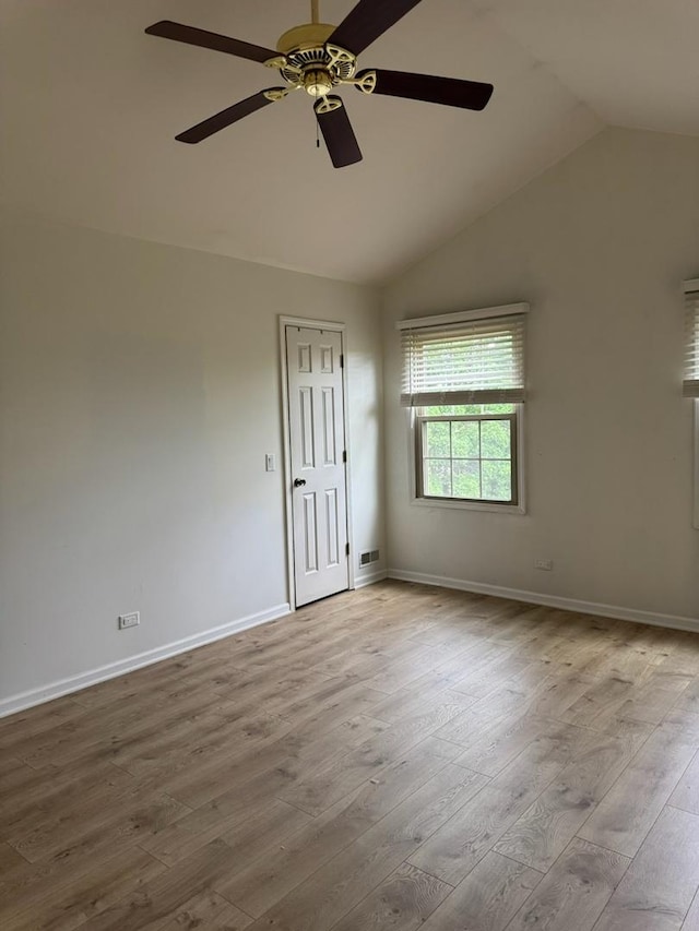 2404 Kenmore Ct, Schaumburg, IL 60193 - empty room with vaulted ceiling, wood finished floors, and a ceiling fan